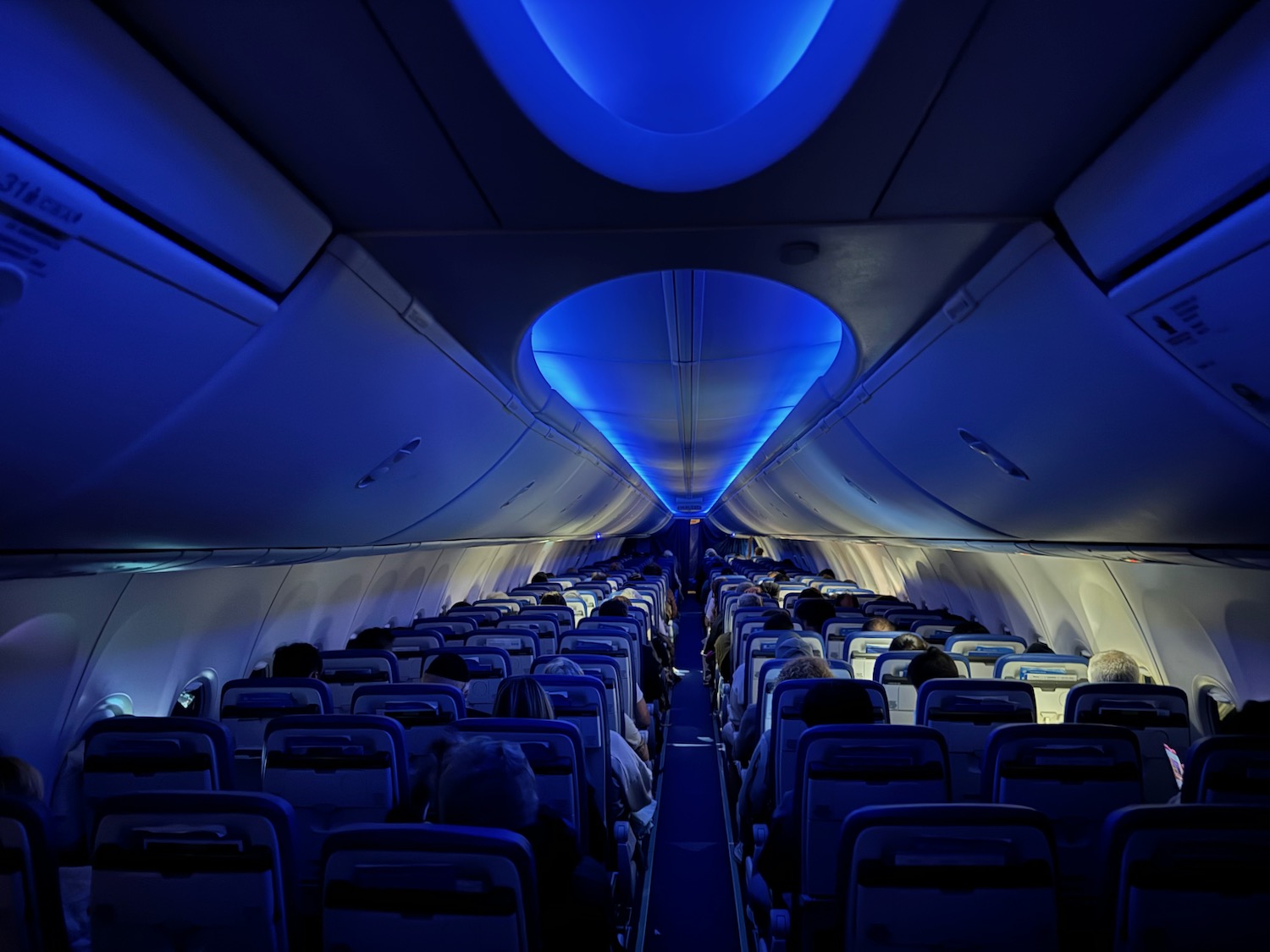 inside an airplane with people sitting in the seats