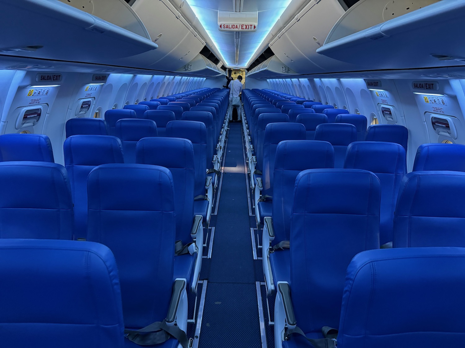 a row of blue seats in an airplane