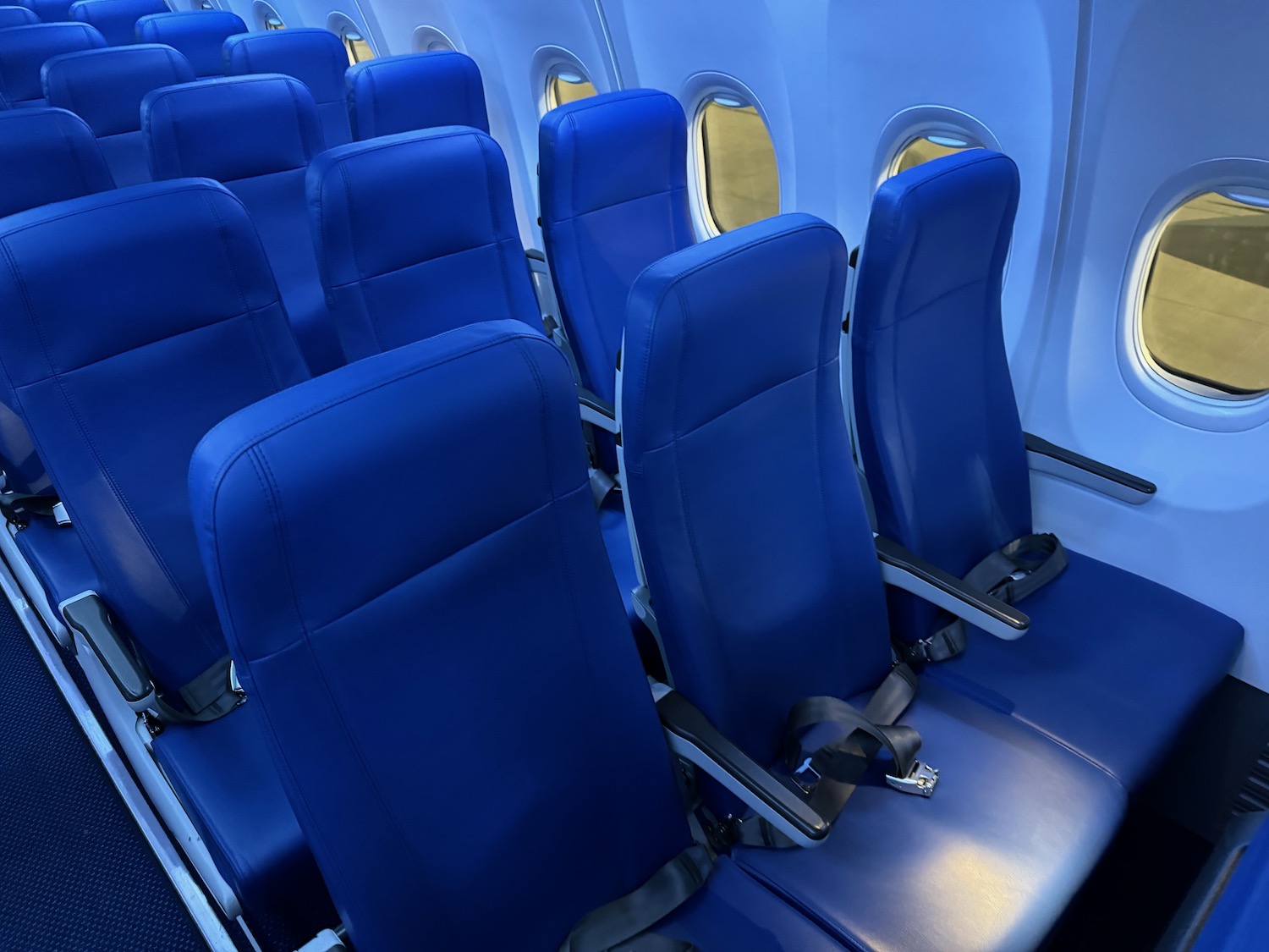 a row of blue seats in an airplane