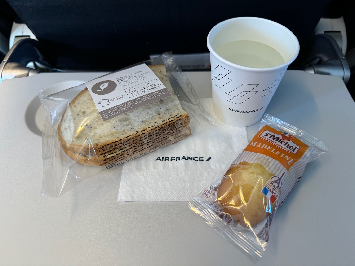 a sandwich and a cup of water on a table