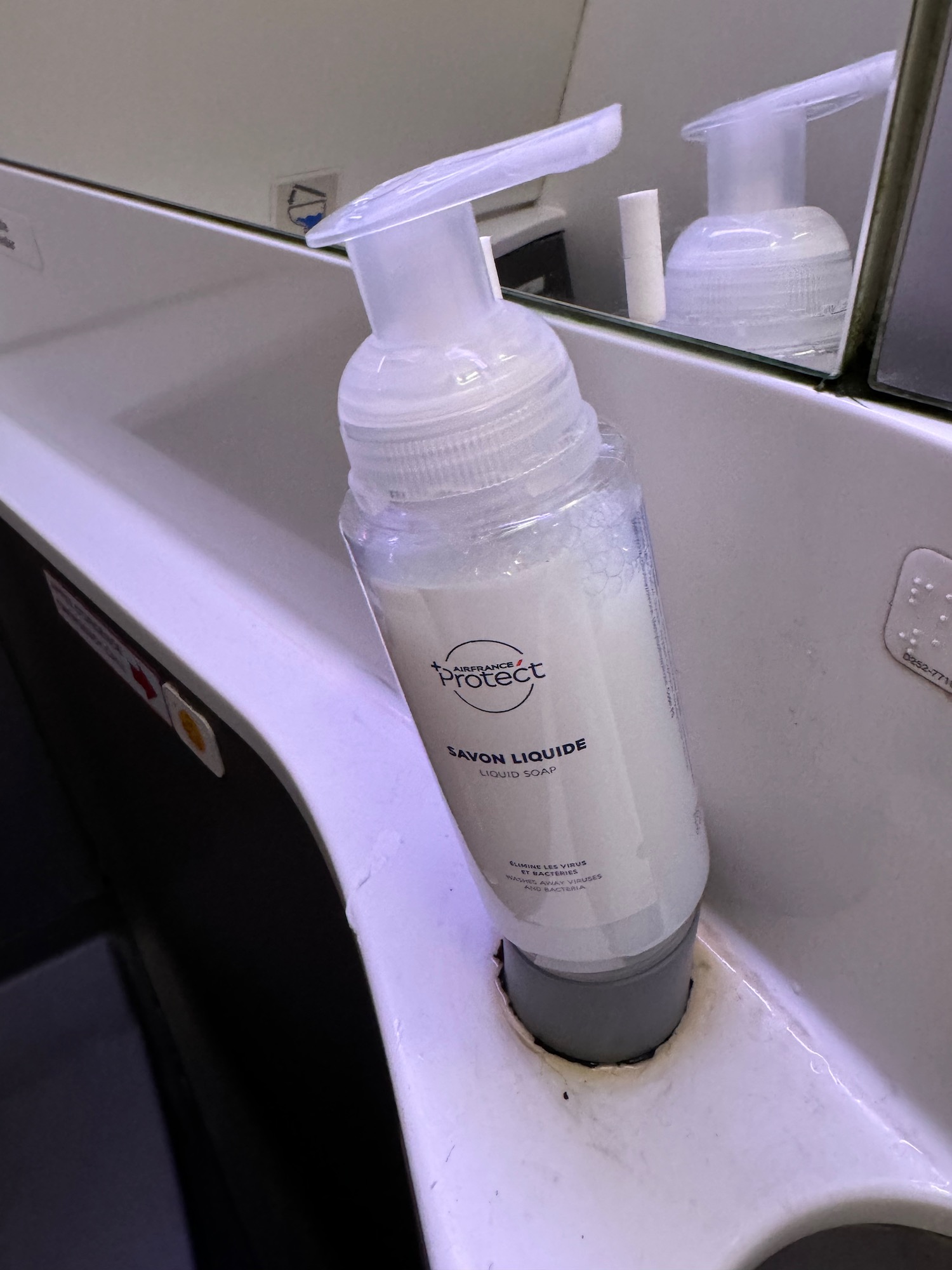 a plastic bottle of liquid on a sink