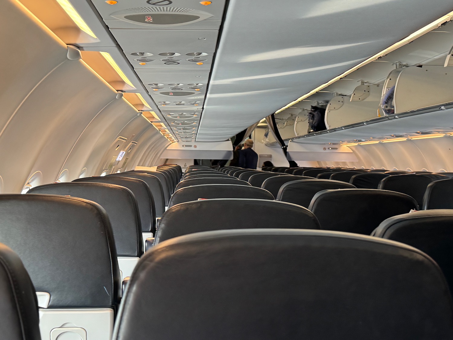 an airplane with seats and people in the background