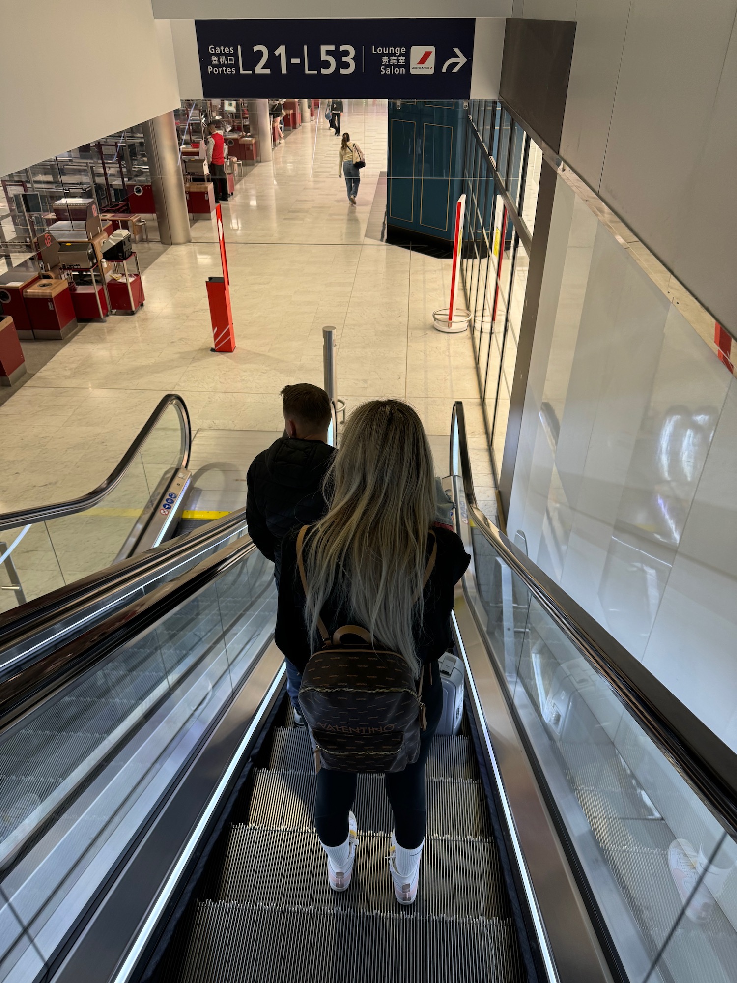 a man and woman on an escalator