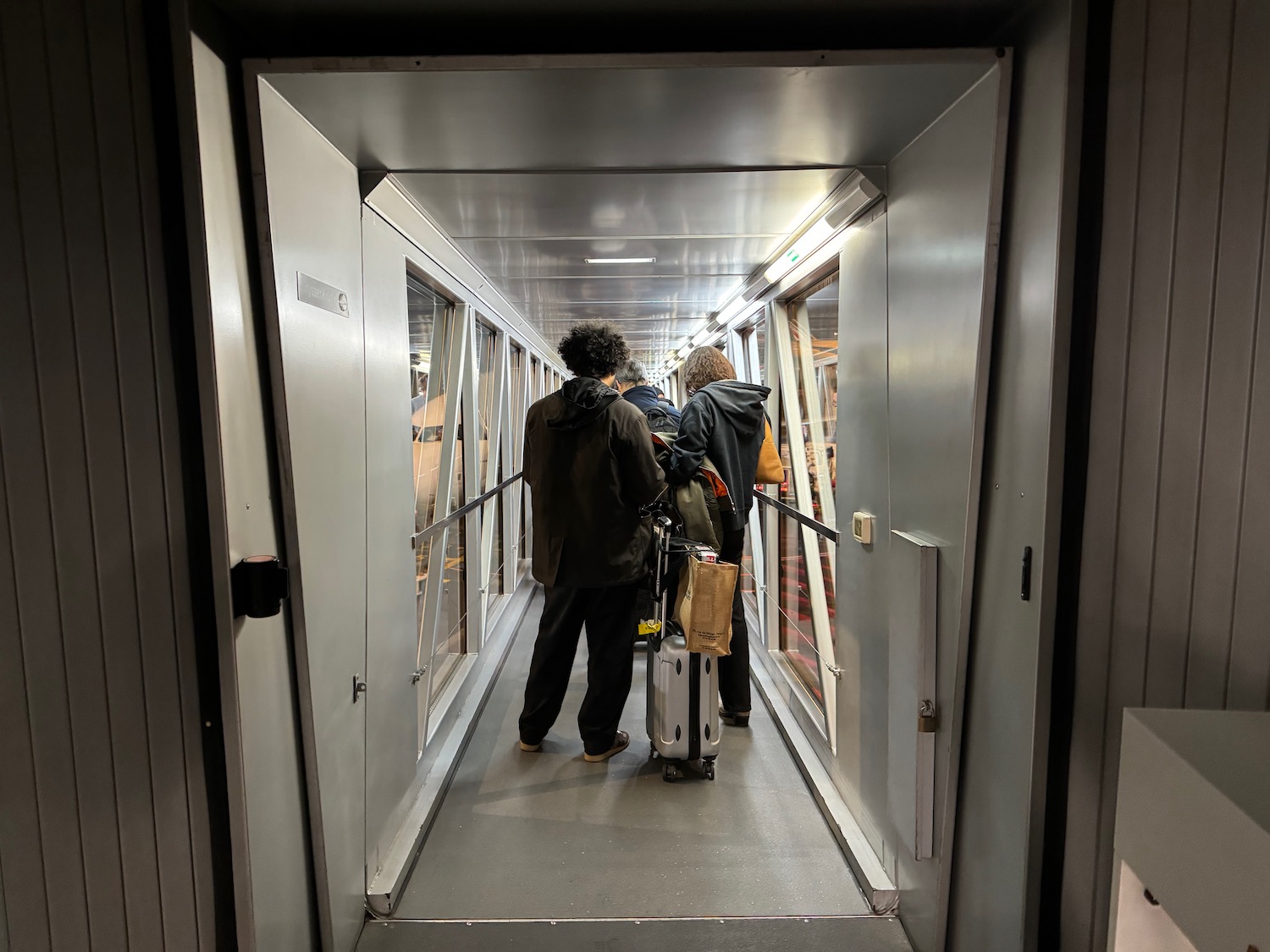 a group of people walking down a walkway