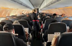 a woman standing in an airplane