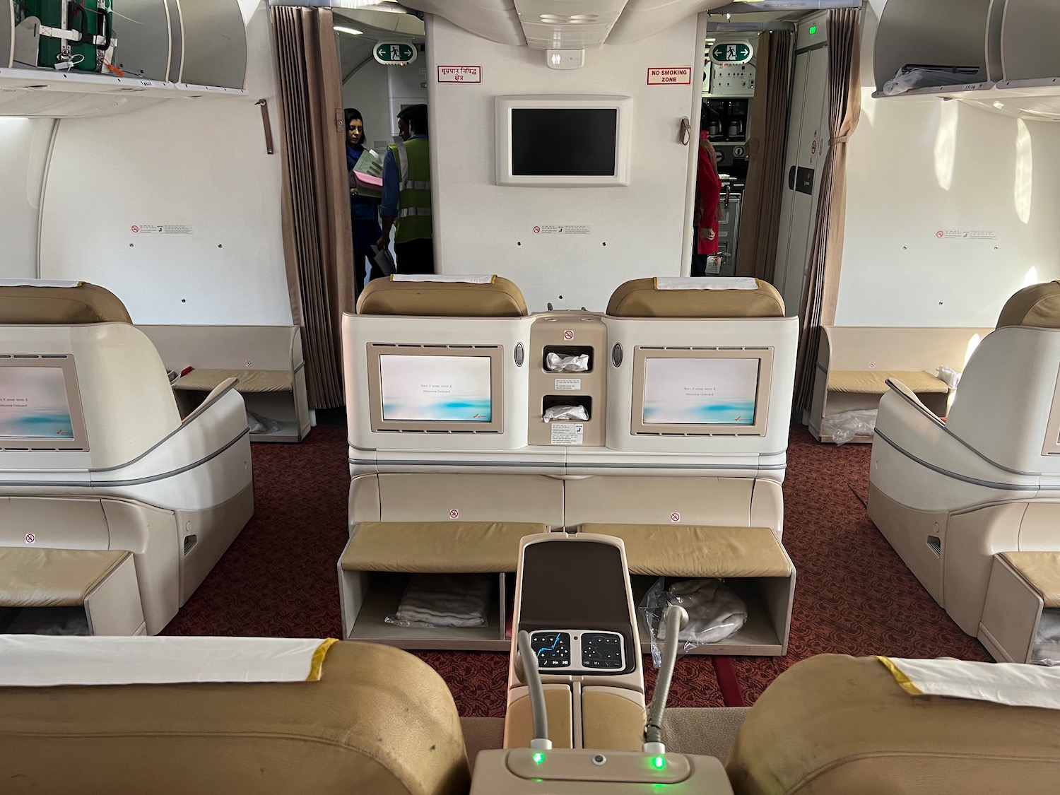 a interior of an airplane with a television and seats