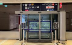 a glass doors with signs and a sign on the front