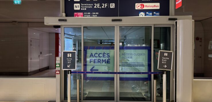 a glass doors with signs and a sign on the front