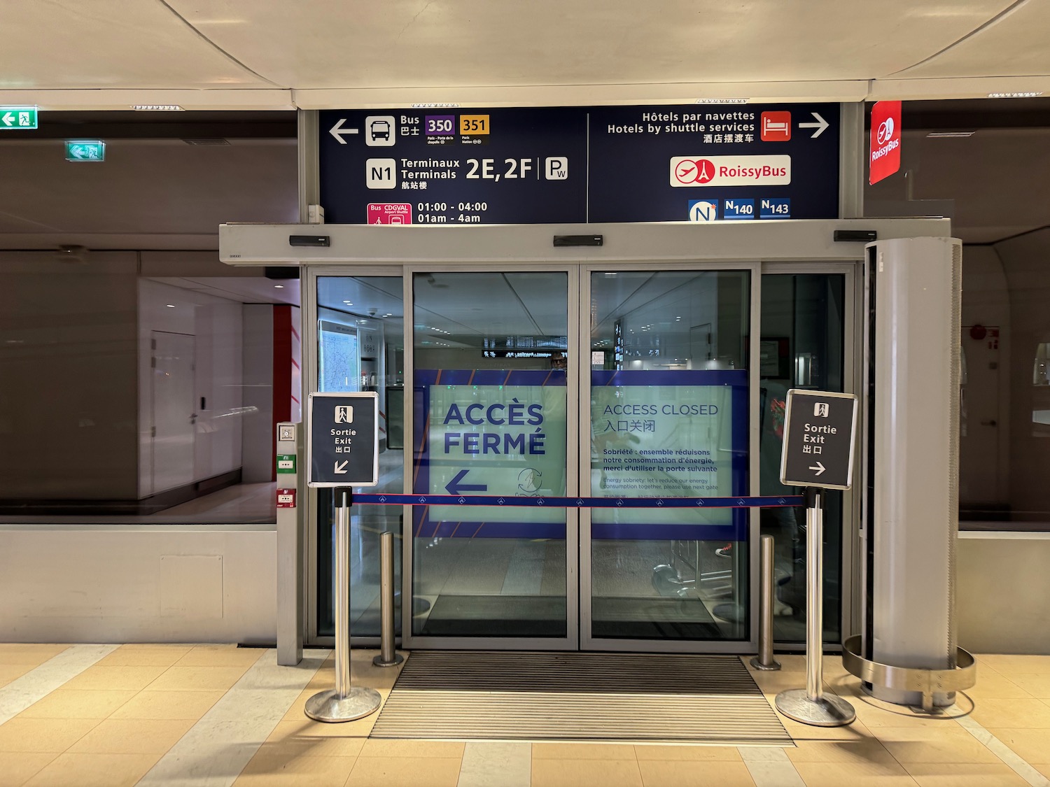 a glass doors with signs and a sign on the front