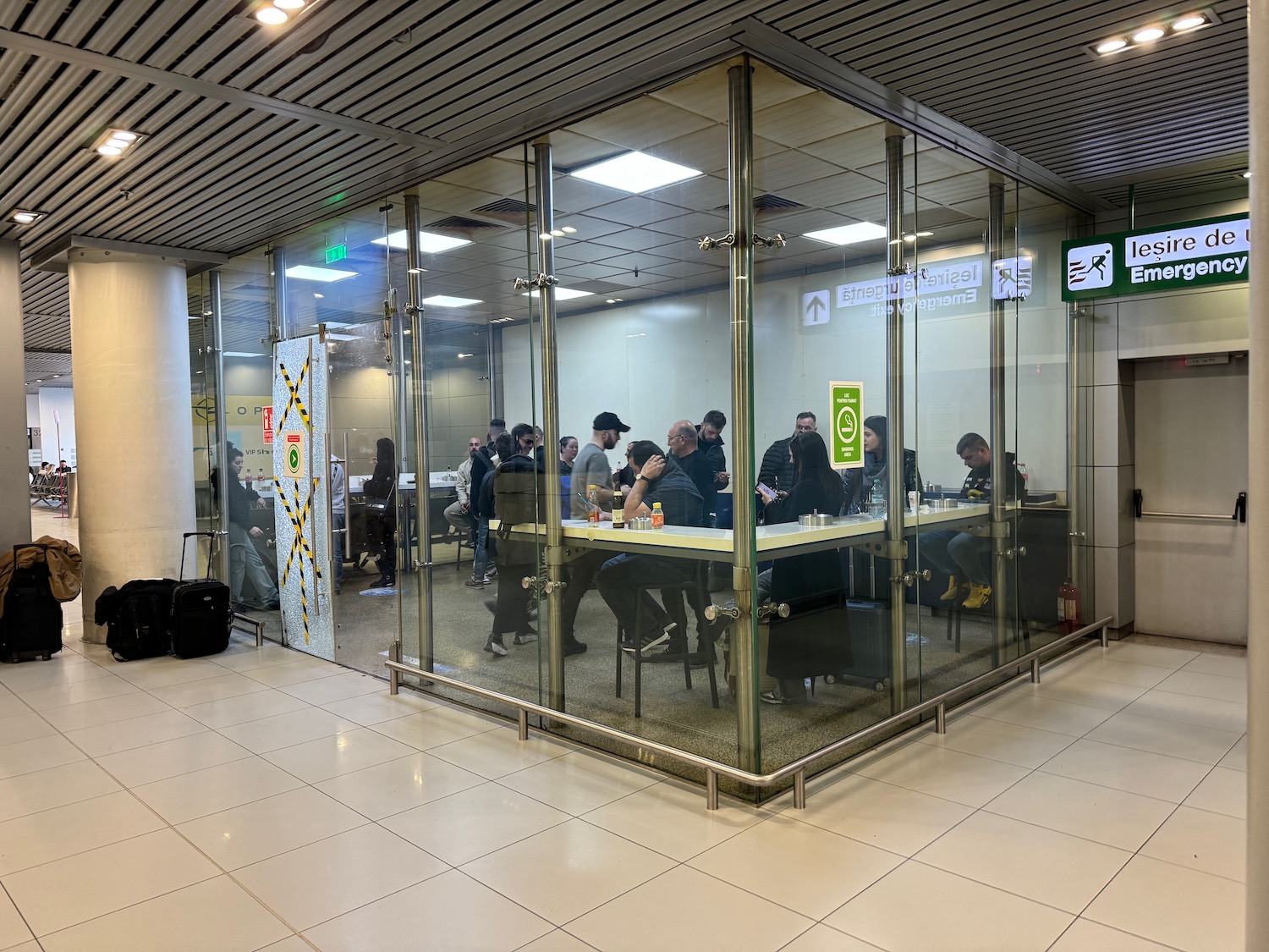 a group of people sitting at a table in a glass room