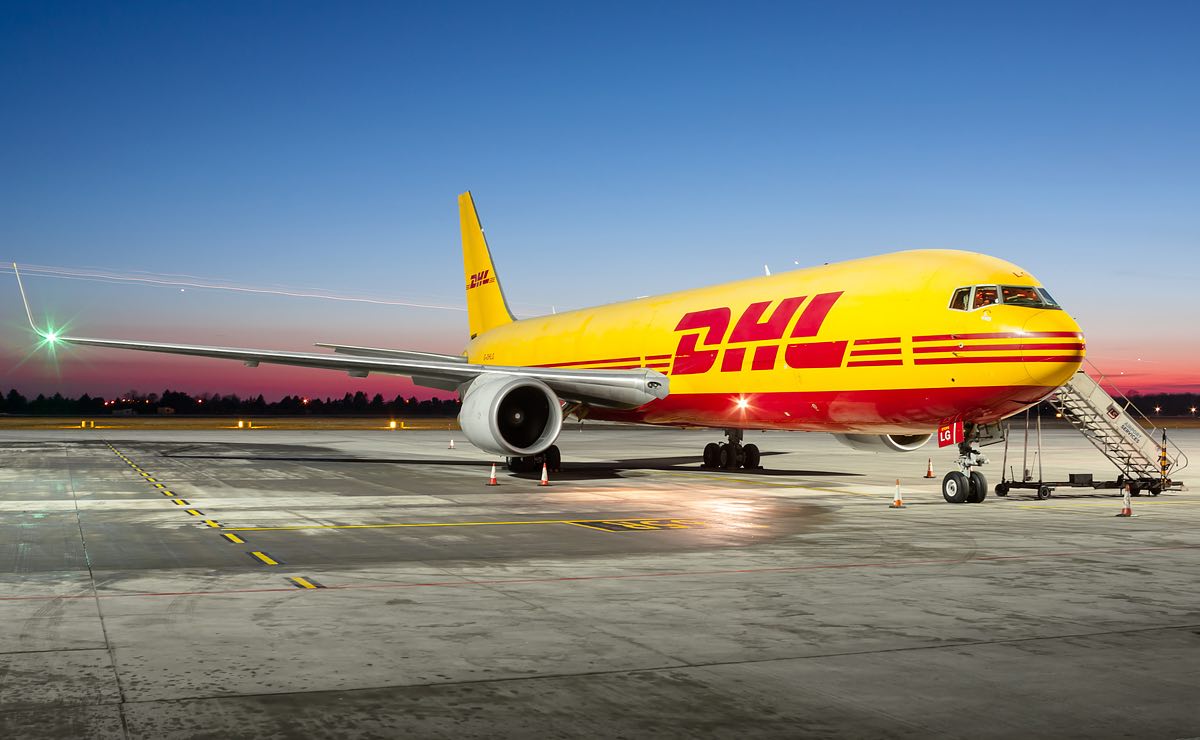 a yellow and red airplane on a runway