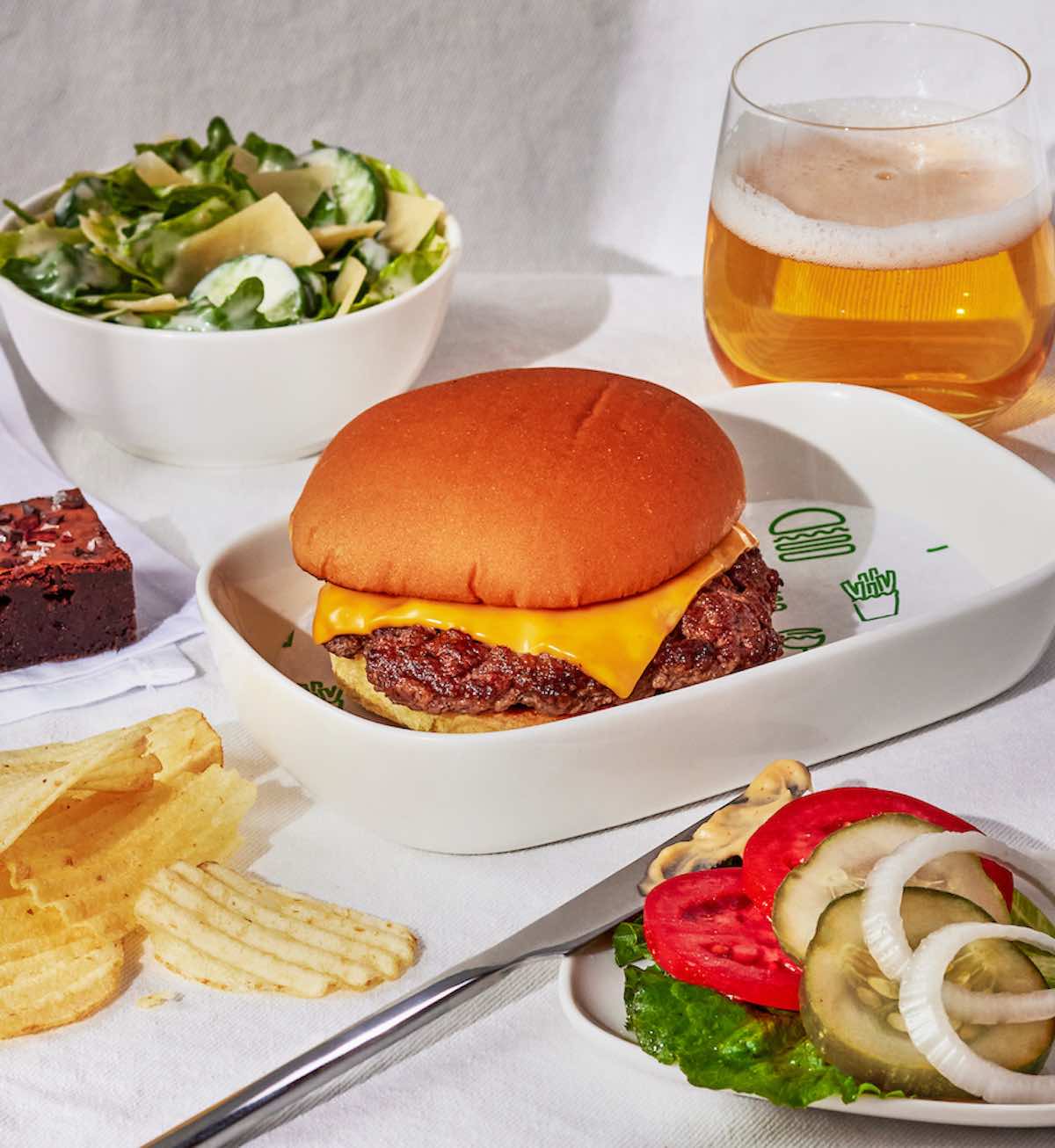 a burger and salad on a plate