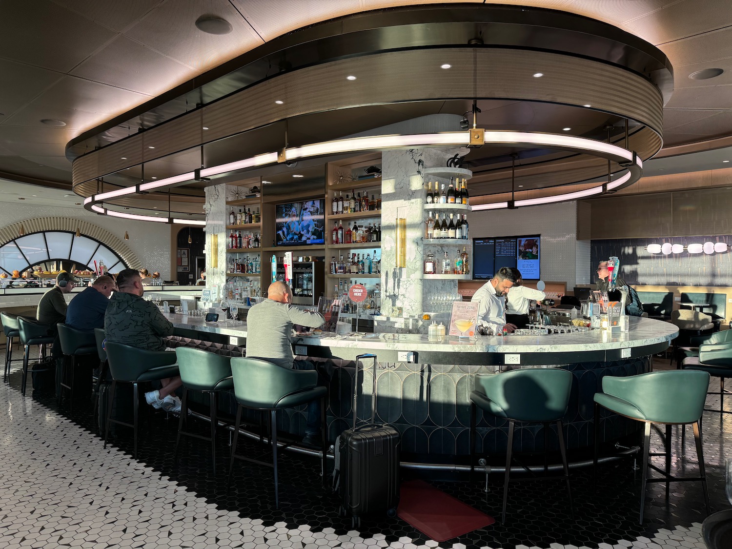 a group of people sitting at a bar