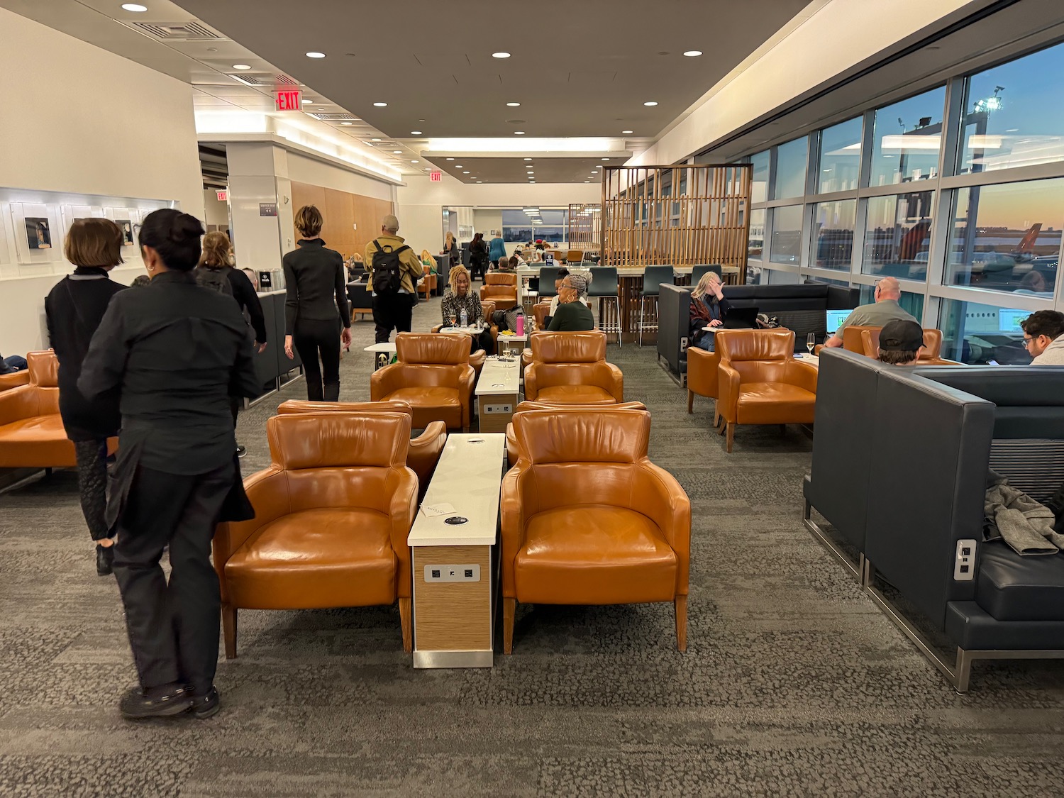 a group of people in a room with chairs and tables