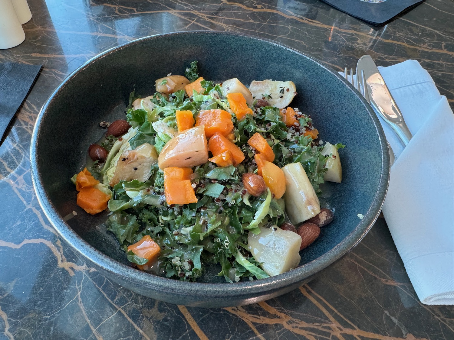 a bowl of salad with vegetables and nuts