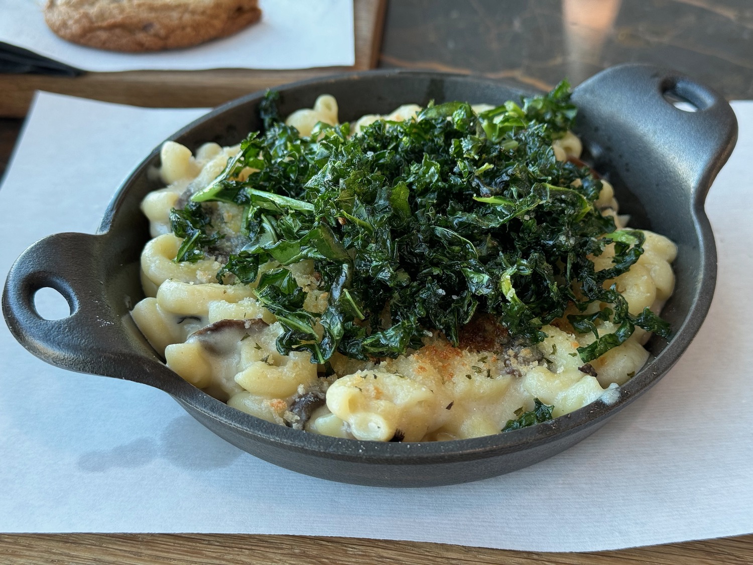 a pan of food with a piece of bread