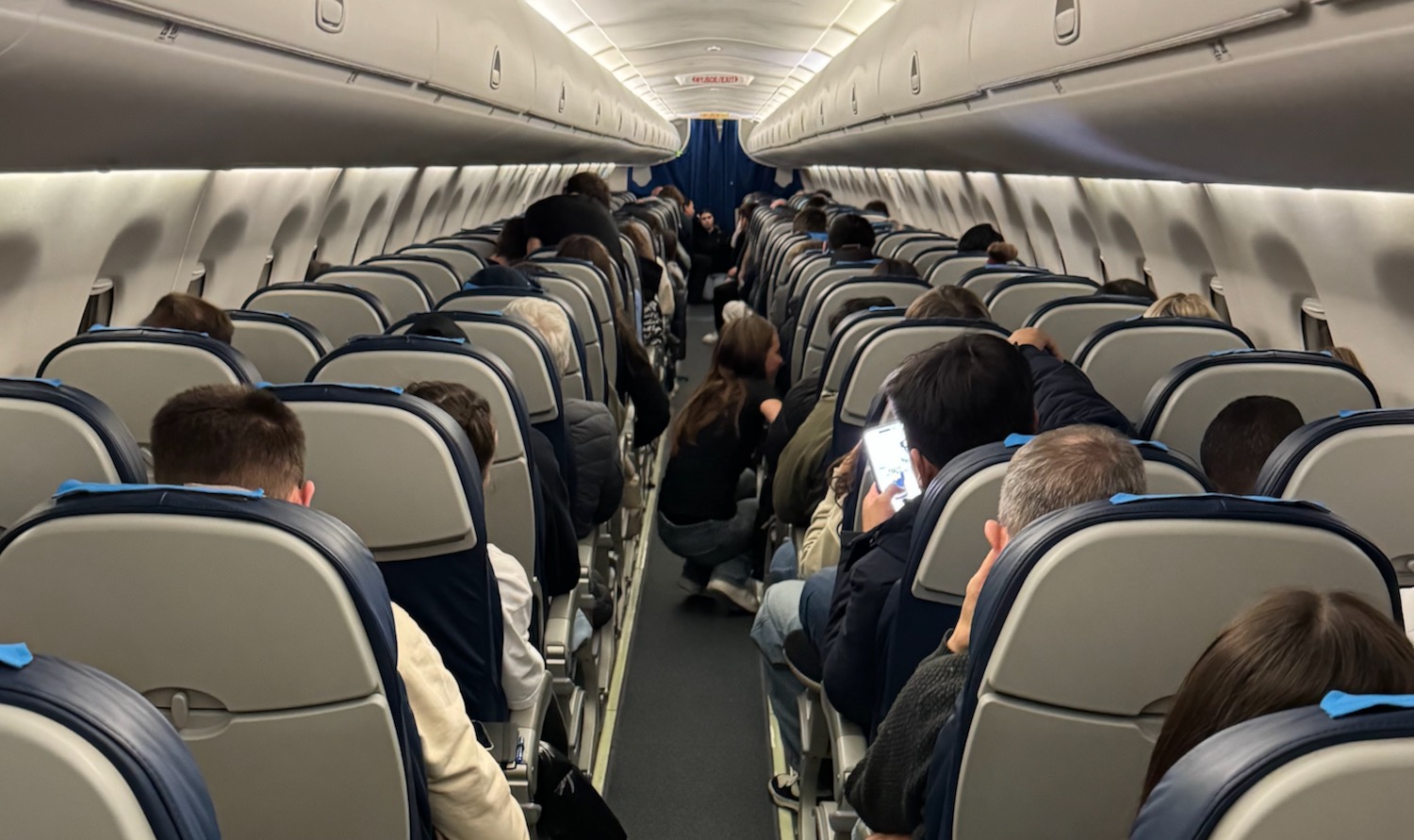 a group of people sitting in an airplane