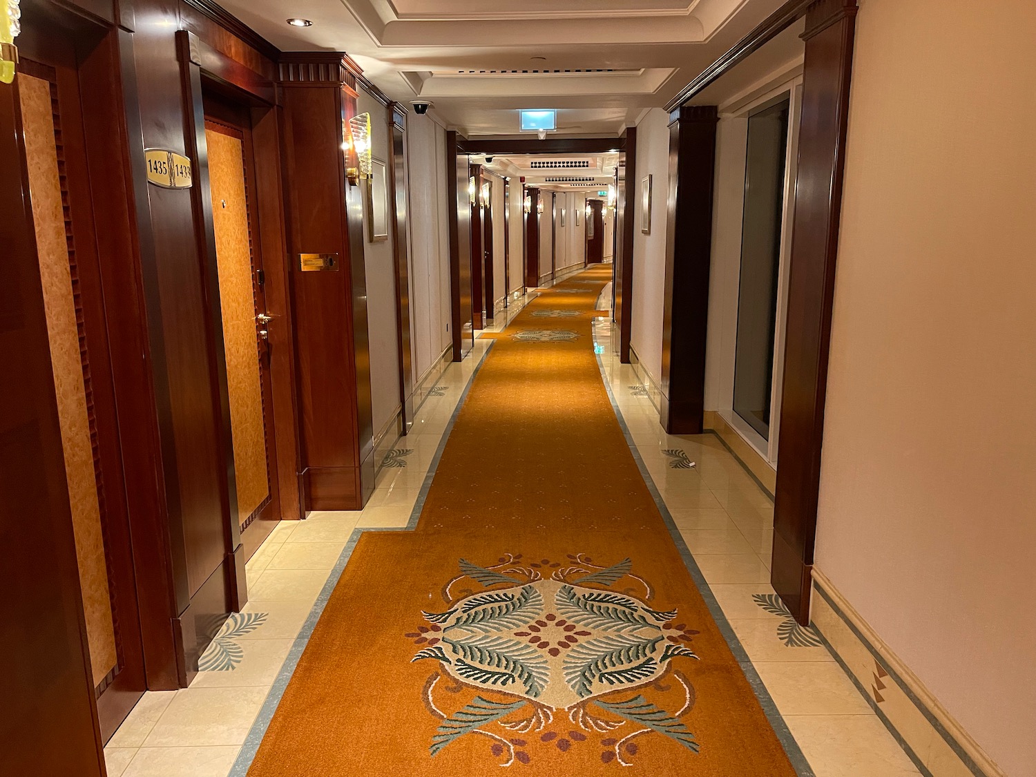 a hallway with a carpet and doors