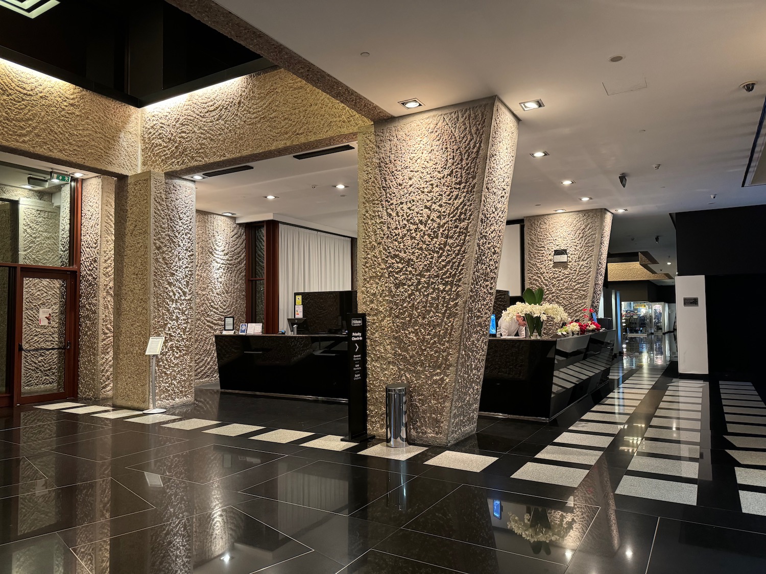 a lobby with a black and white tiled floor