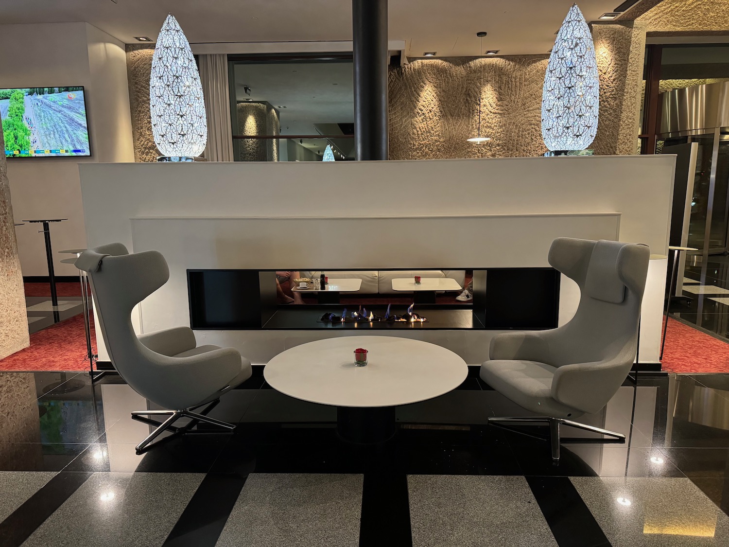 a white table with chairs in front of a fireplace