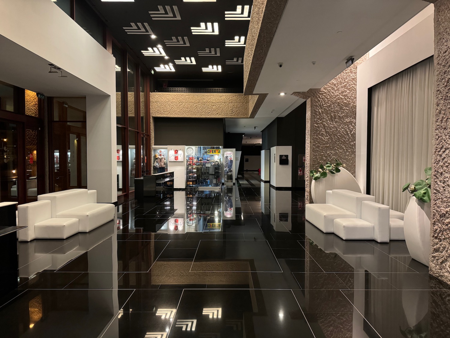 a black floor with white couches and a black tile floor