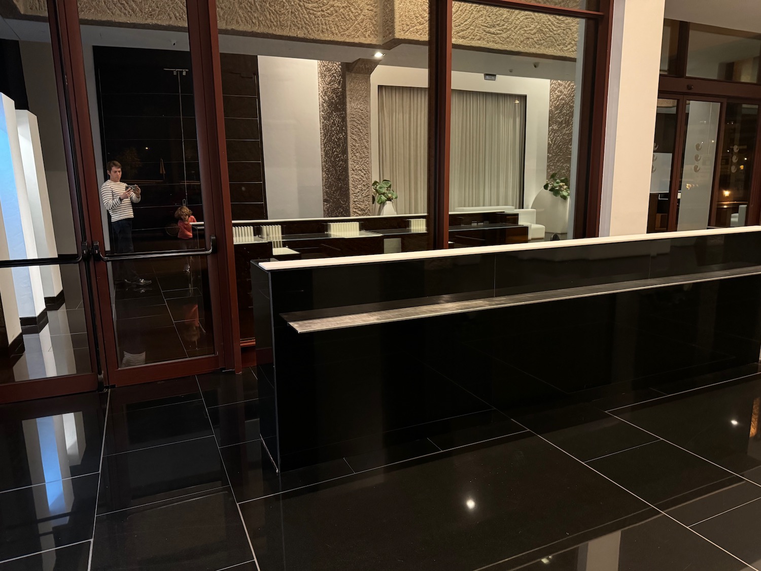 a black tiled floor with a black counter and a black counter with a white and brown door