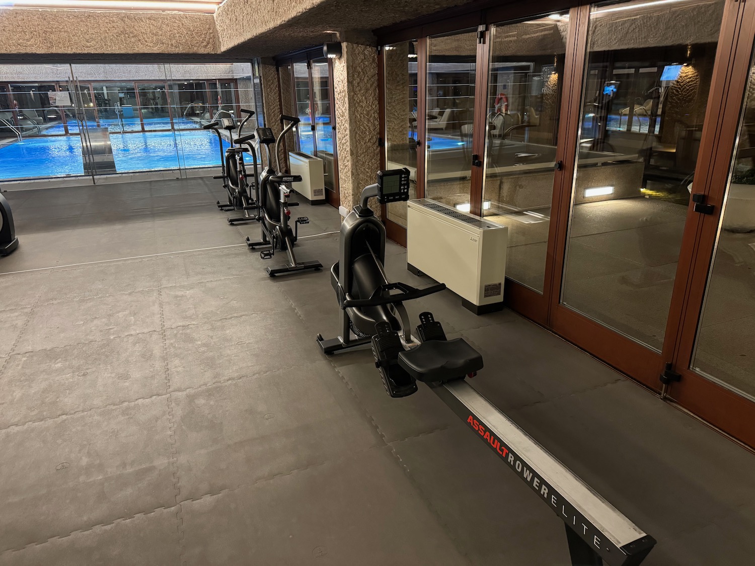 a row of exercise bikes in a room