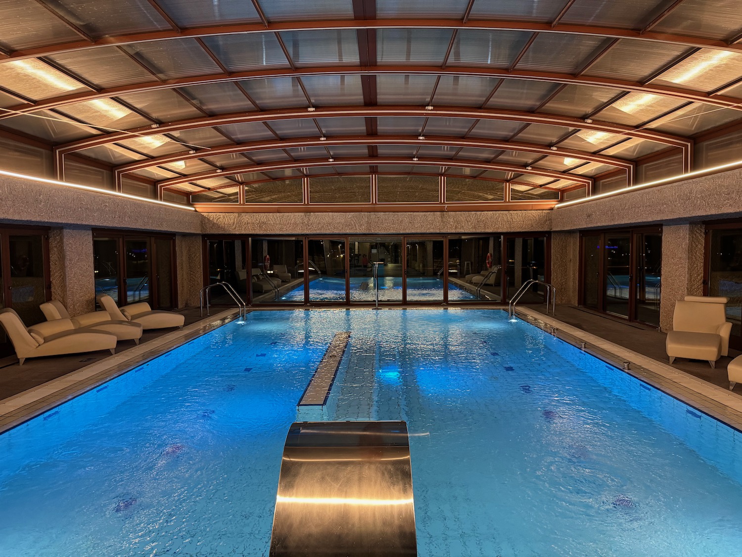 a indoor pool with a glass roof