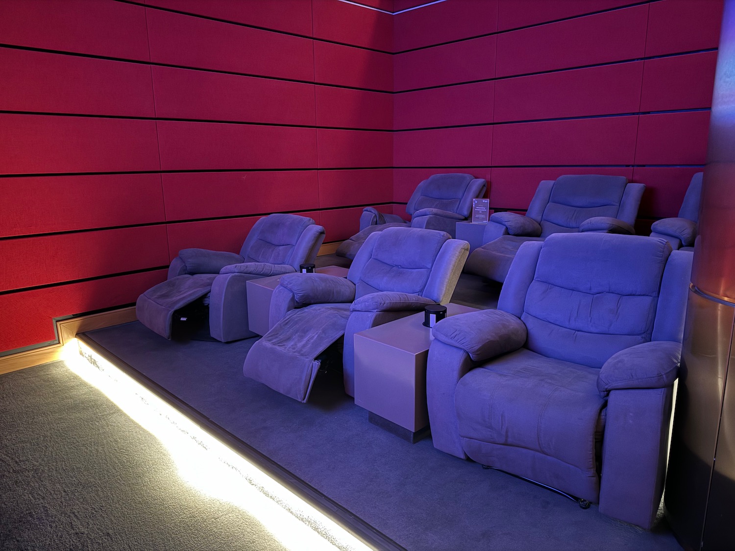 a room with purple chairs and a red wall