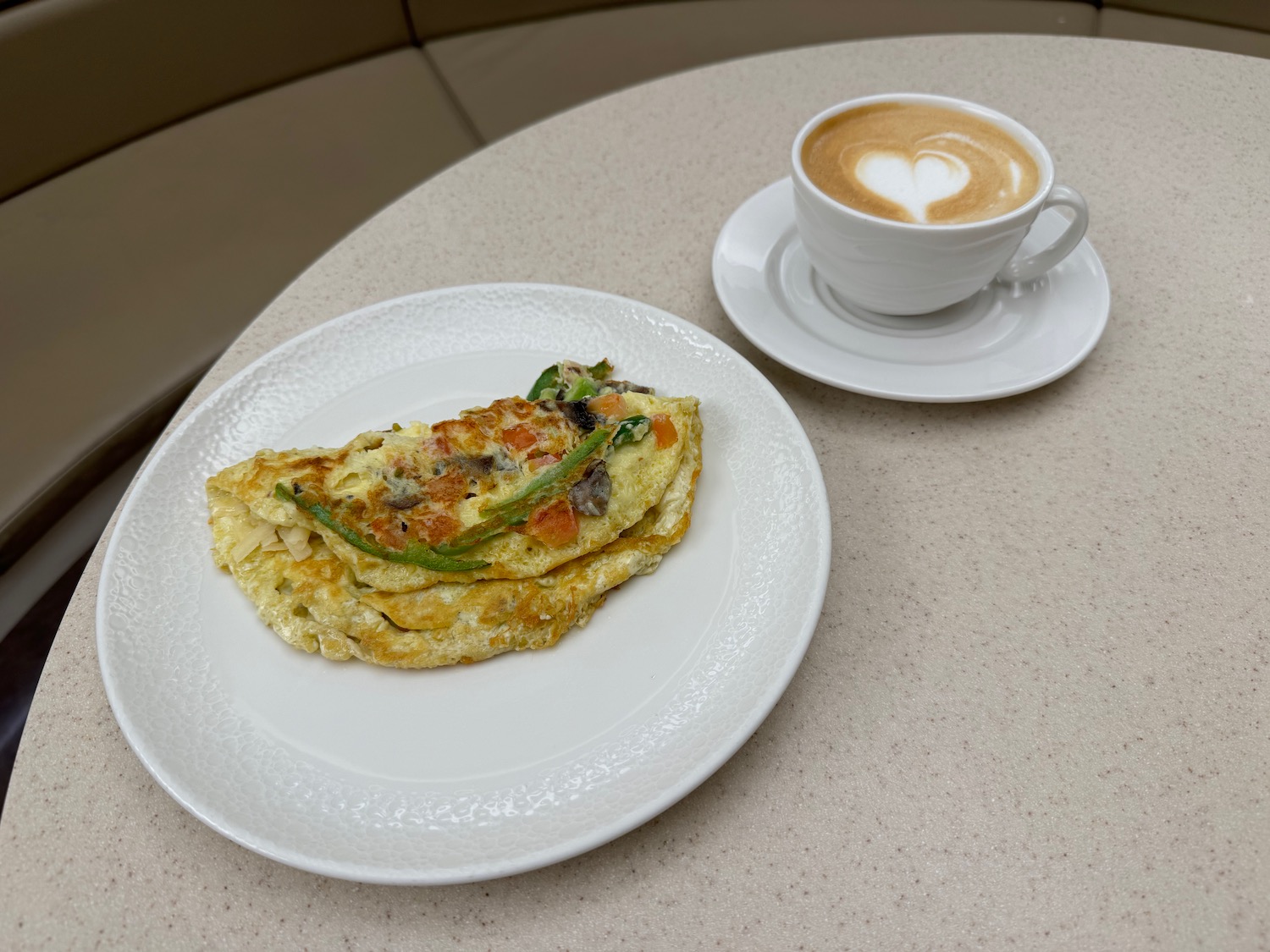 a plate of food and a cup of coffee