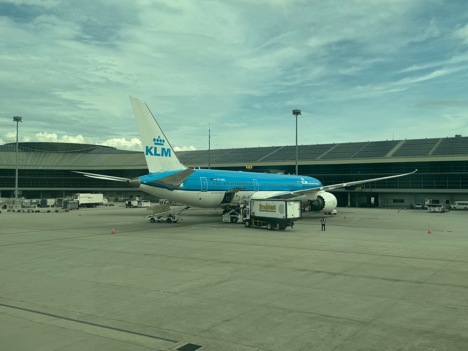 a blue and white airplane at an airport