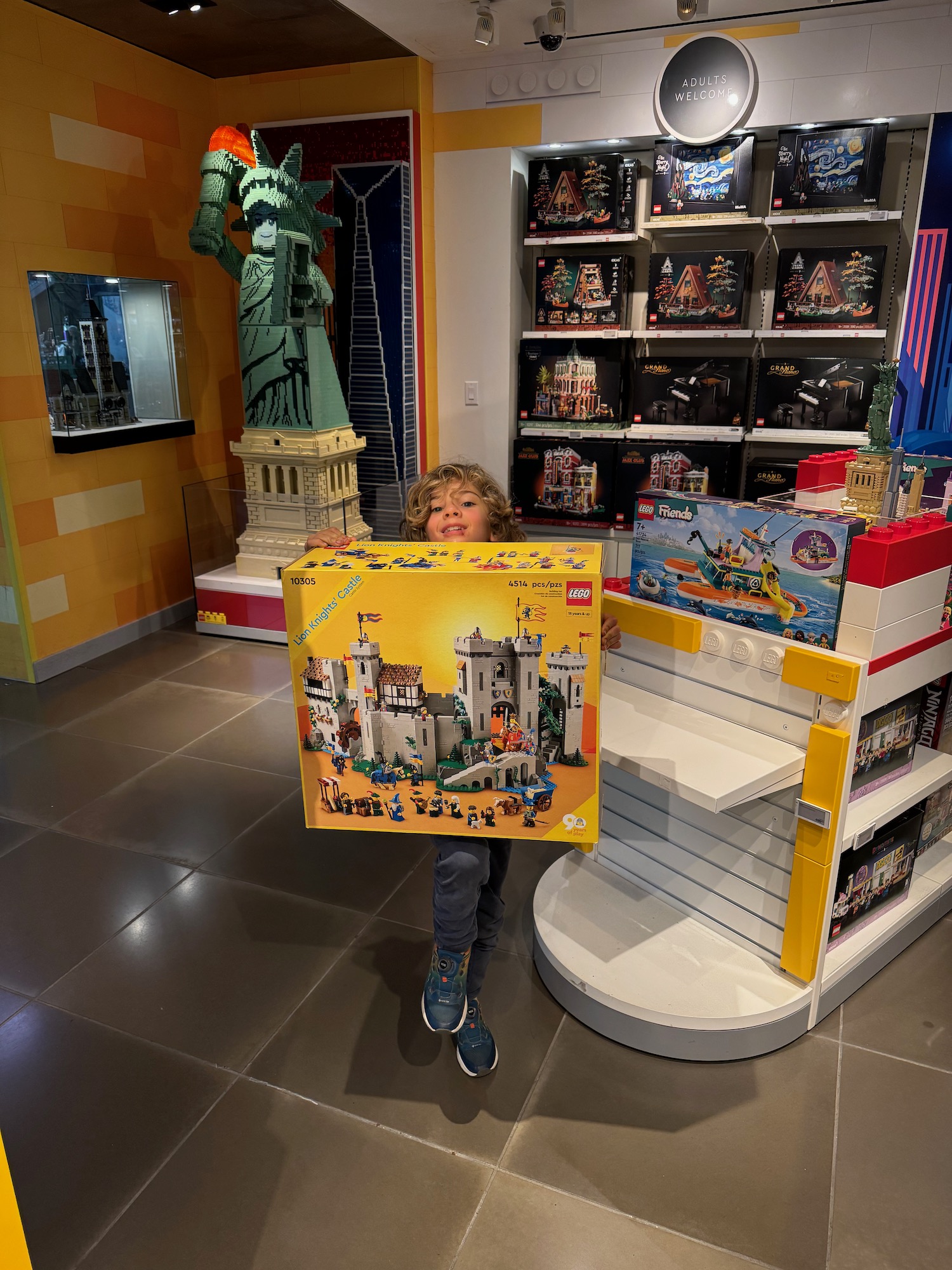 a child holding a puzzle in a store