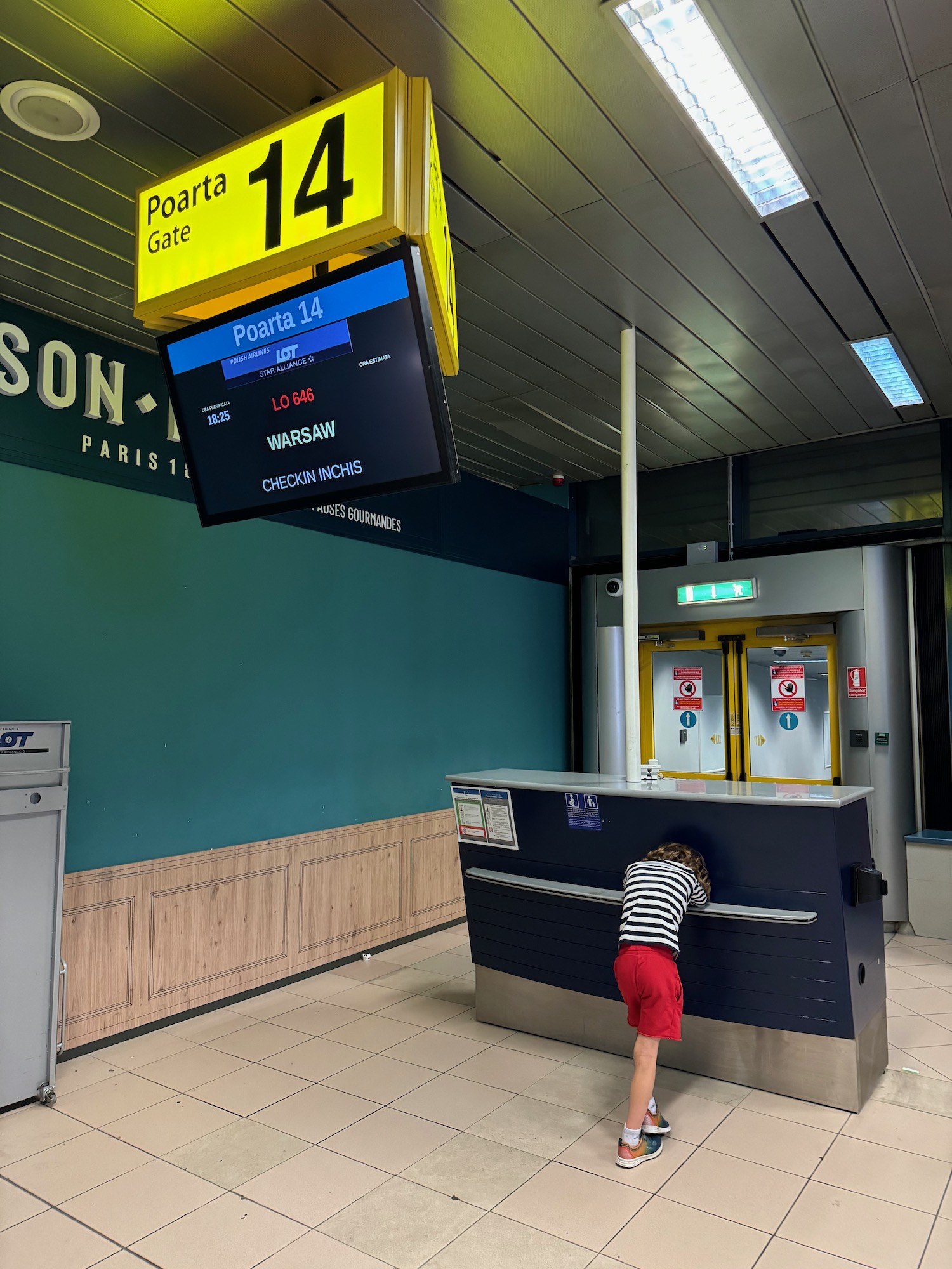 a child hiding behind a counter