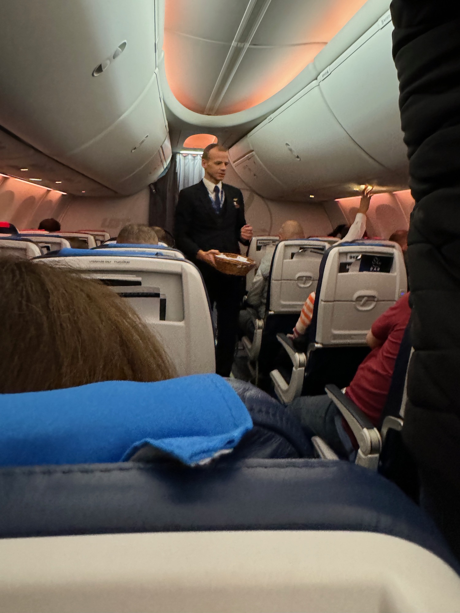 a man in a suit standing in an airplane