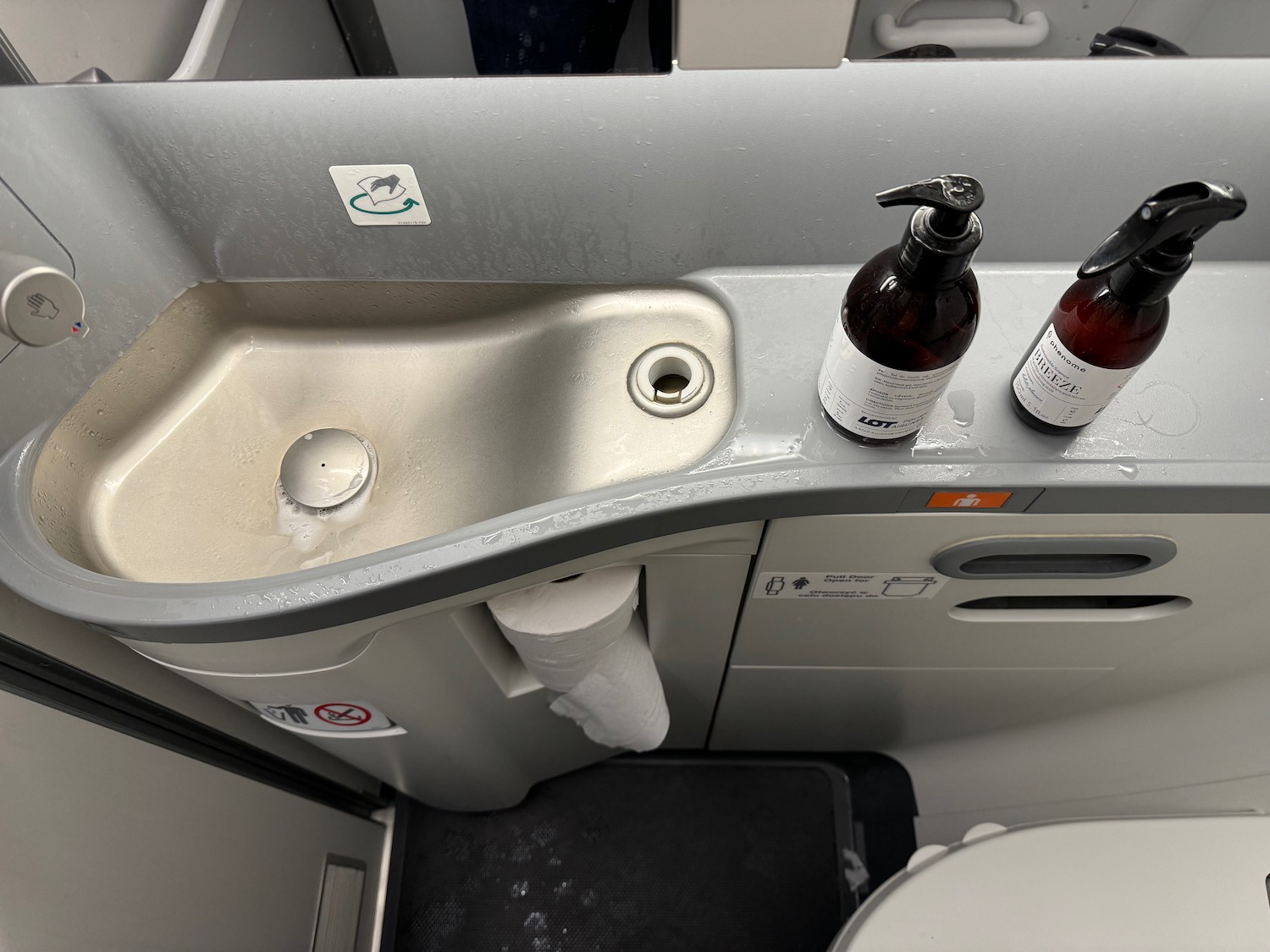 a sink with soap and bottles on it