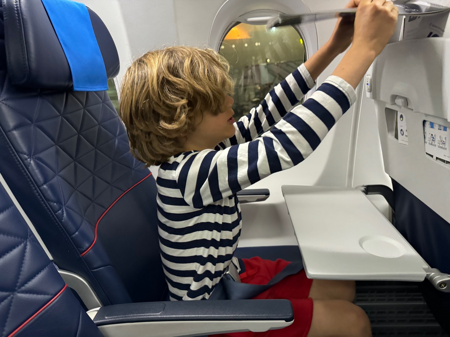 a boy sitting in an airplane