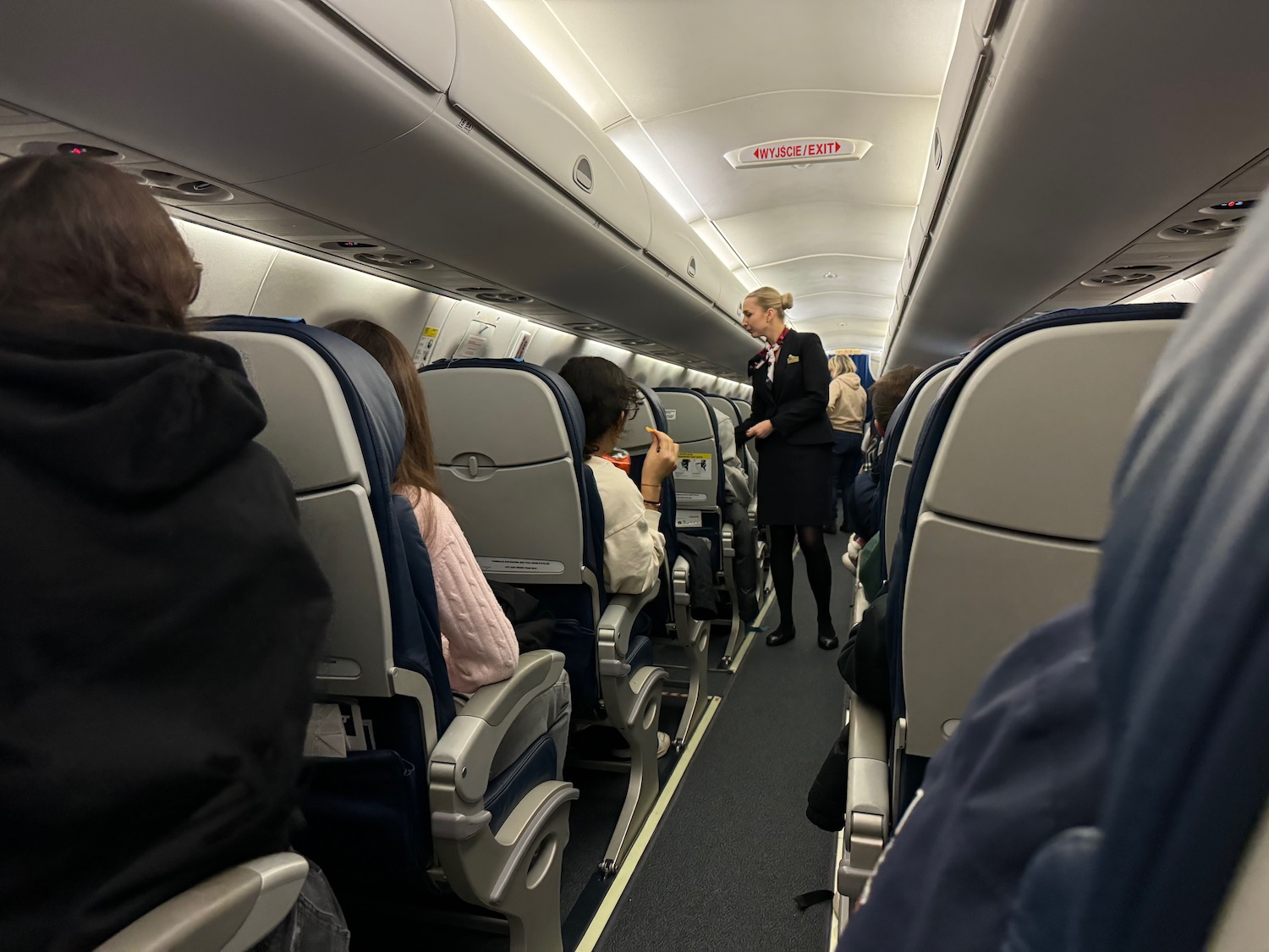 a woman standing in an airplane