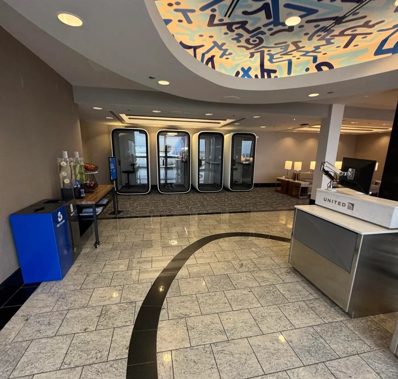 a lobby with a blue and white ceiling