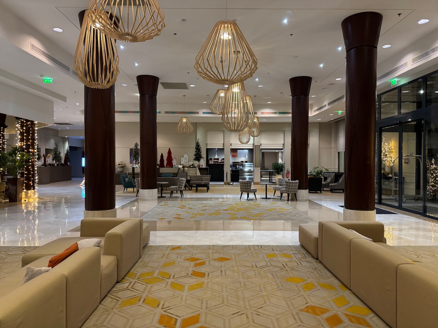 a lobby with a large chandelier and couches