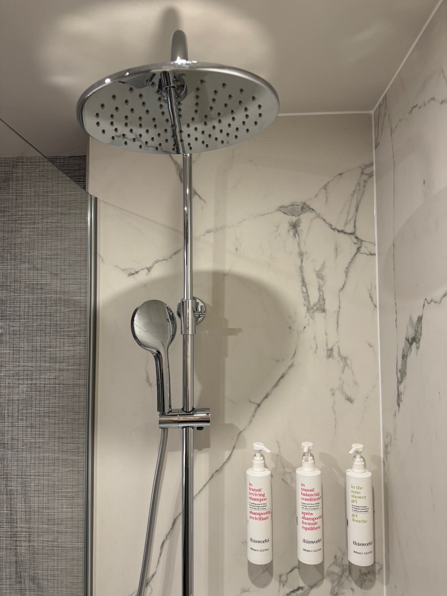 a shower head with soap and shampoo bottles