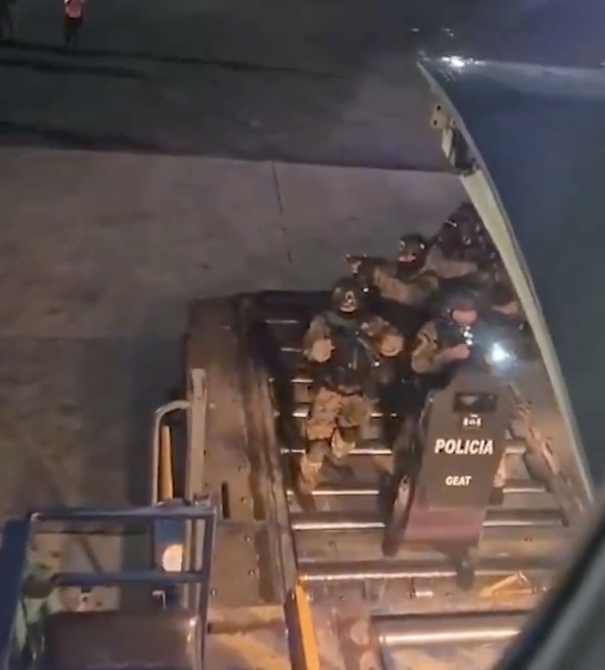 a group of people in uniform standing on a truck