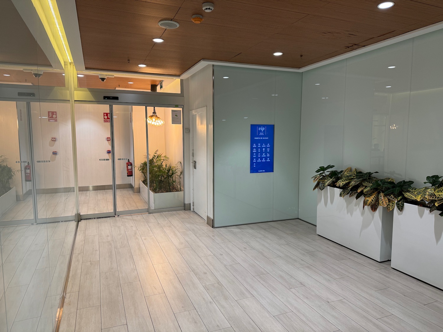 a room with glass doors and plants