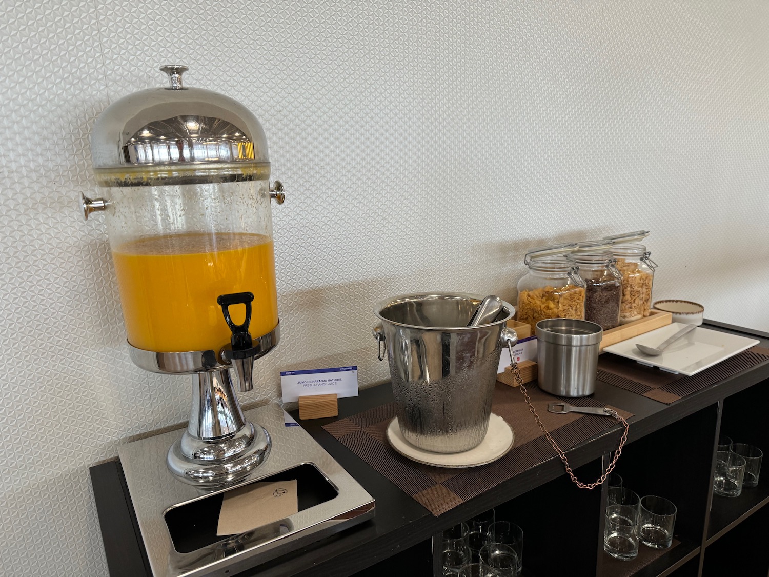 a beverage dispenser and buckets on a table