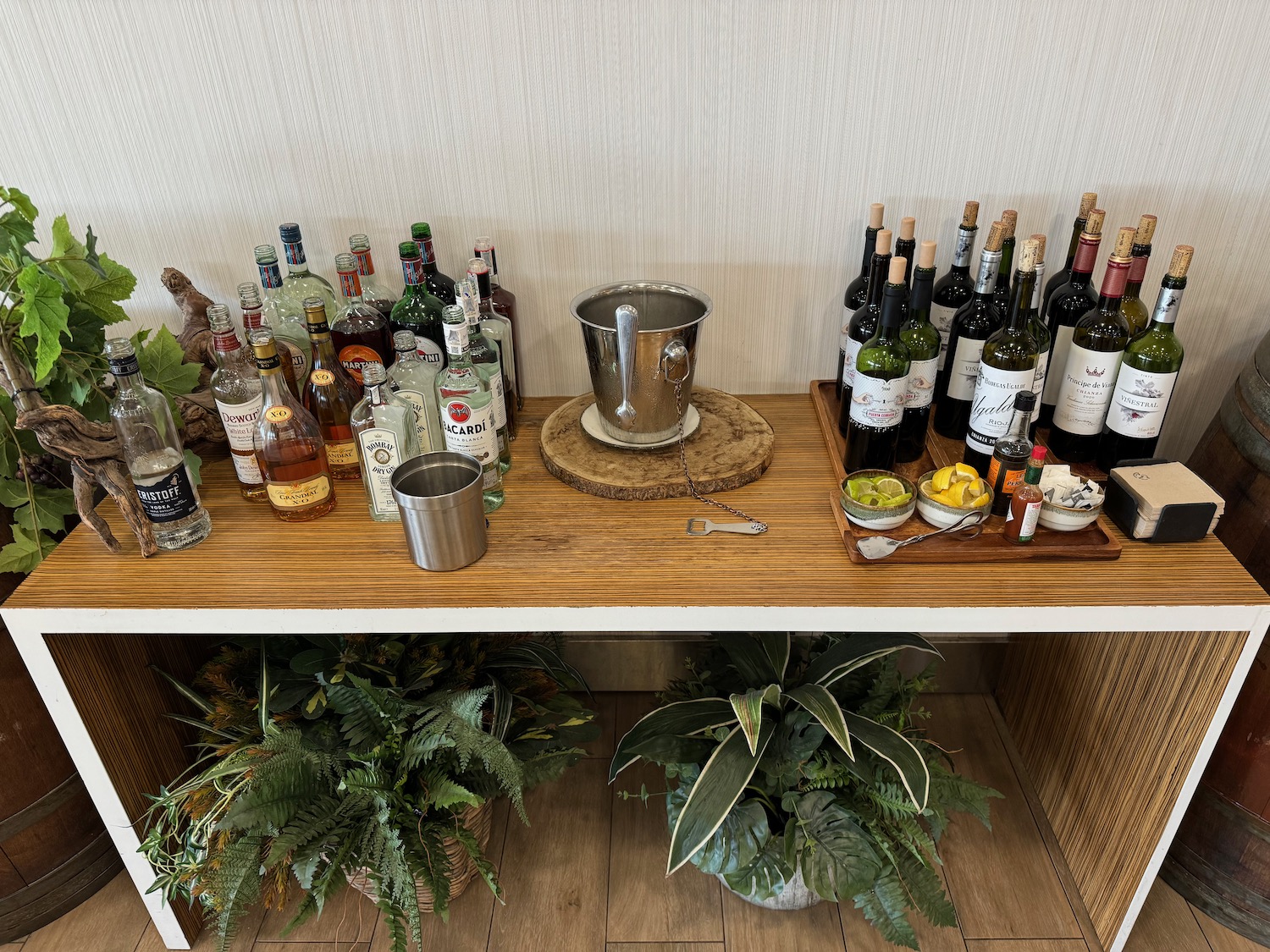 a table with bottles of alcohol and plants