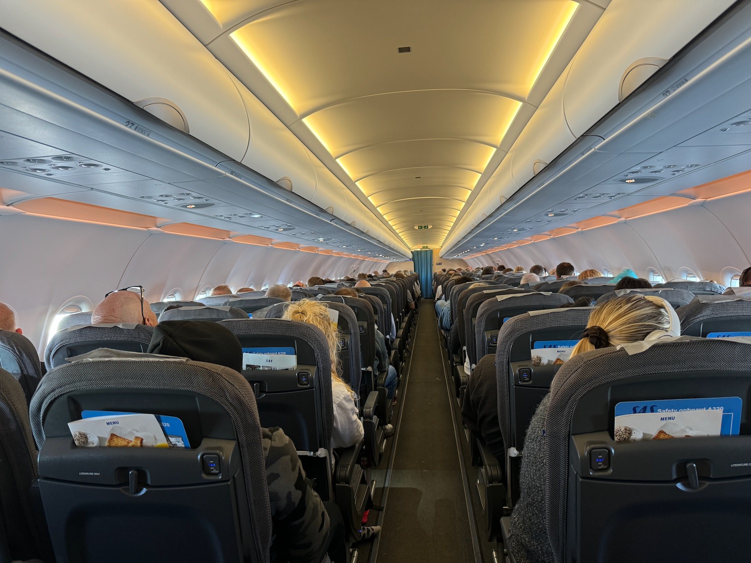 a group of people sitting in an airplane