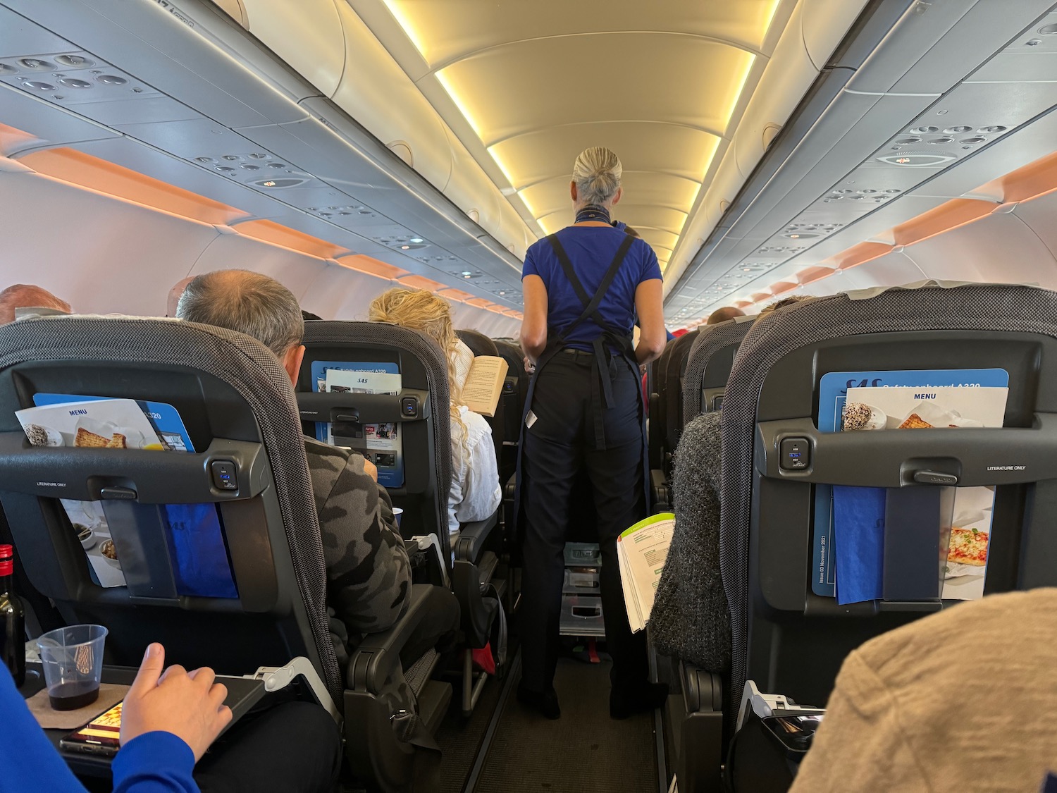 a woman standing in an airplane