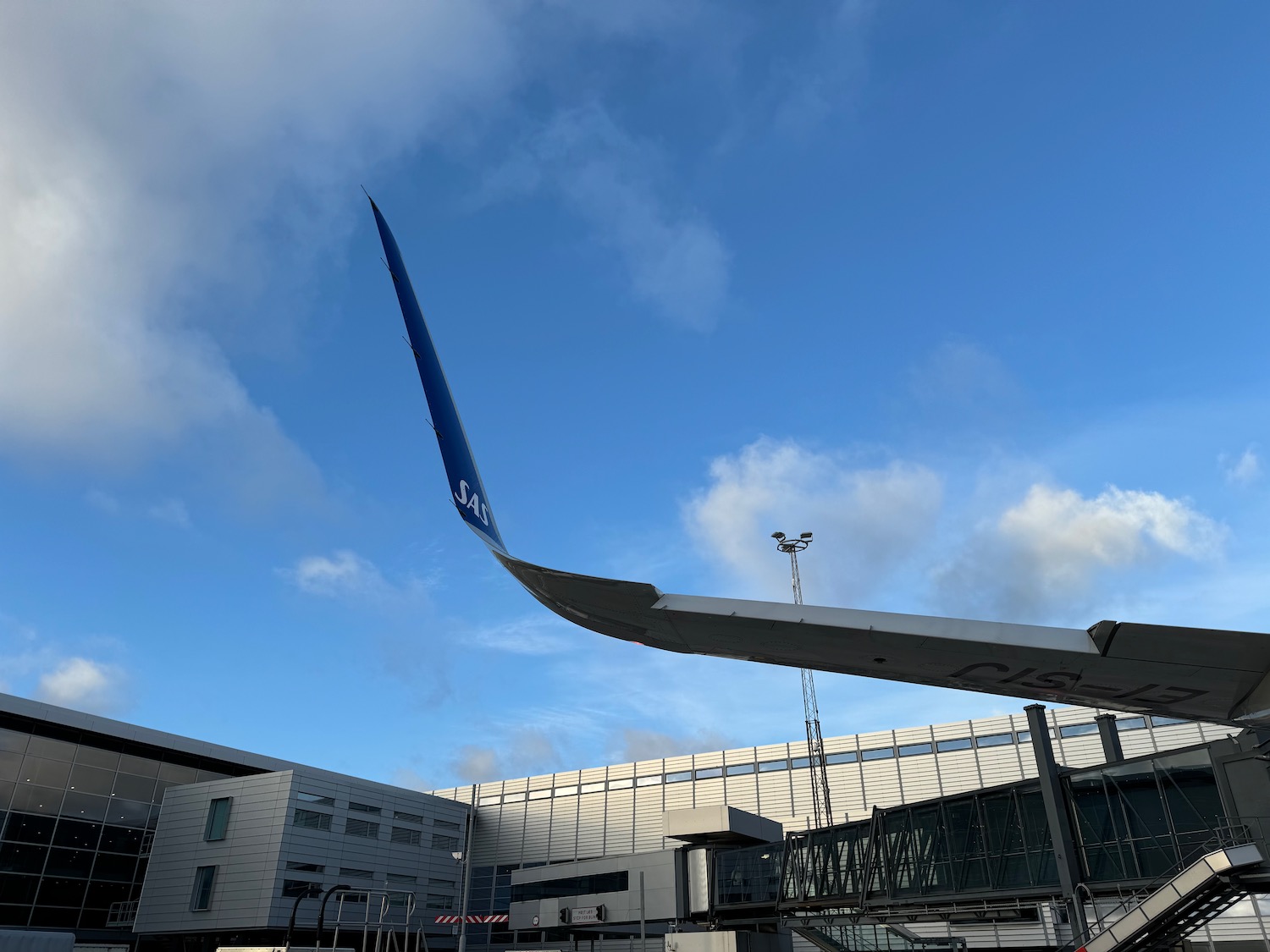 an airplane wing in front of a building