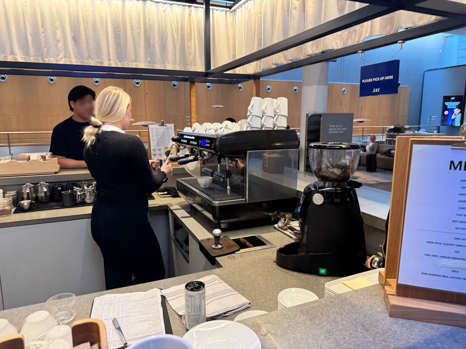 a woman making coffee in a restaurant