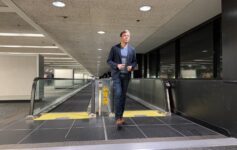 a man standing on an escalator