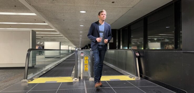 a man standing on an escalator